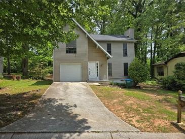 Charming two-story home with a one-car garage and front lawn at 3948 Valley Brook Rd, Snellville, GA 30039