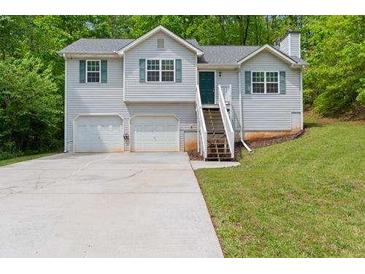 Charming home with a two-car garage and well-maintained lawn at 401 Farm Brook Ln, Dallas, GA 30157
