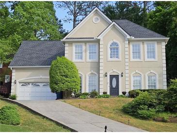 Charming two-story home featuring a gray roof, well-manicured lawn, and a convenient two-car garage at 2122 Riverbirch Ne Ct, Lawrenceville, GA 30044