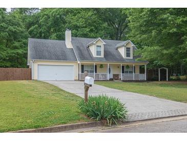 Charming traditional home with a welcoming front porch and a well-maintained lawn at 420 Bear Cub Path, Social Circle, GA 30025