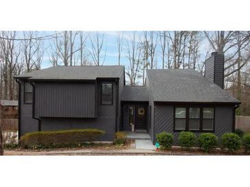 Charming two-story home with a grey exterior, well-maintained landscaping, and inviting front entrance at 3404 Vinings North Se Trl, Smyrna, GA 30080