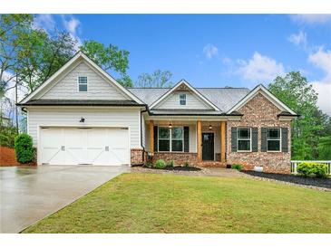 Charming single-story home with brick and siding exterior, lush lawn, and two-car garage at 8230 Dawson View Way, Cumming, GA 30028