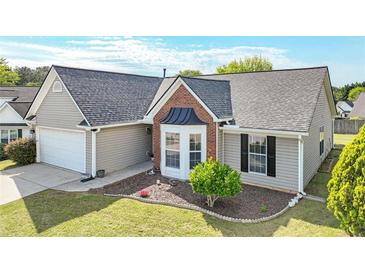Charming single-story home featuring a well-manicured lawn and attached two-car garage at 2602 Midler Ct, Buford, GA 30519