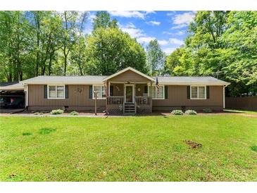 Charming single-story home with a well-manicured front yard and inviting front porch at 5855 Willis Ln, Cumming, GA 30040