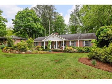 Charming brick home features a large front yard with lush landscaping at 4527 Sims Ct, Tucker, GA 30084