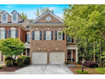 Charming brick home with a two-car garage and manicured landscaping at 5407 Waters Edge Trl, Roswell, GA 30075