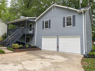 Charming two-story home featuring a two-car garage and a welcoming front porch at 214 Sweetwater Cir, Powder Springs, GA 30127