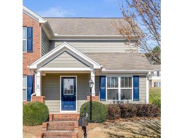 Charming home featuring a covered entrance, well-manicured landscaping, and a classic architectural design at 577 Cypher Dr, Suwanee, GA 30024