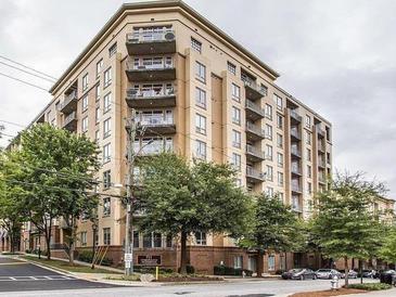 Upscale apartment building featuring multiple balconies and well-maintained landscaping at 711 Cosmopolitan Ne Dr # 123, Atlanta, GA 30324