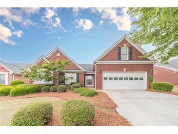 Charming brick home with manicured landscaping, a two-car garage, and inviting curb appeal at 1022 Pecan Grove Pl, Lawrenceville, GA 30046