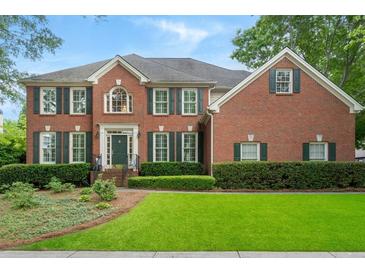 Beautiful two-story brick home with a well-manicured lawn and dark green shutters at 400 Fieldstone Lndg, Alpharetta, GA 30005
