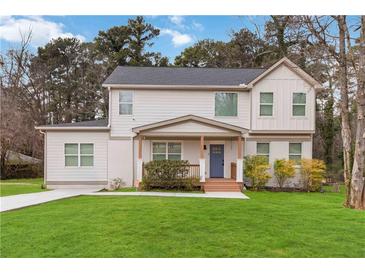 Charming two-story home with a well-manicured lawn, inviting porch, and a mix of painted brick and siding at 2206 Loring Ct, Decatur, GA 30032
