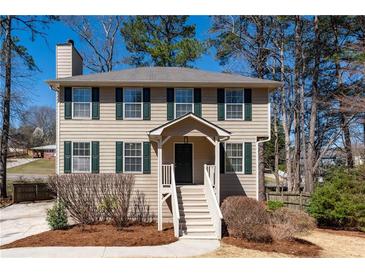 Charming two-story home featuring beige siding, black shutters, and a welcoming front porch with well-manicured landscaping at 3362 Alexis Ct, Marietta, GA 30066