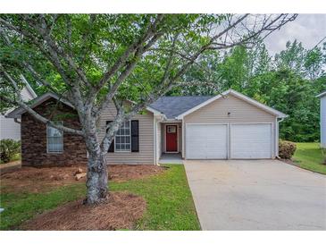 Charming single-story home with a stone accent wall, two-car garage, and well-manicured lawn at 4096 Waldrop Hills Dr, Decatur, GA 30034