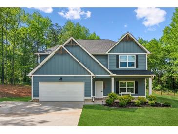 Charming two-story home boasts a well-maintained lawn, a two-car garage, and eye-catching curb appeal at 7031 Palomino Trl, Winston, GA 30187
