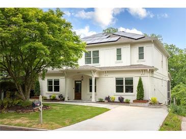 Beautiful two-story home with solar panels, a well-manicured lawn, and mature landscaping at 331 Gordon Ne Ave, Atlanta, GA 30307