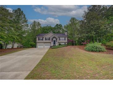 Charming two-story home features a well-manicured lawn and a two-car garage at 332 Red Fox Dr, Canton, GA 30114