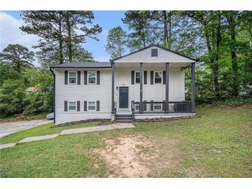 Charming two-story home with a covered front porch, and traditional landscaping at 6547 Demere Dr, Morrow, GA 30260