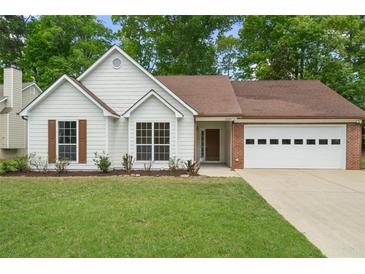 Charming single-story home featuring a well-manicured lawn and a two-car garage at 1095 Athena Ct, Acworth, GA 30101