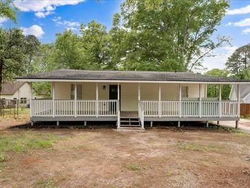 Inviting single-story home featuring a spacious front porch and a well-maintained yard at 5438 Hiram Lithia Springs Rd, Powder Springs, GA 30127