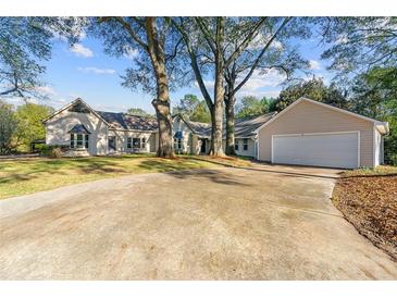 Charming single-story home with a large driveway and well-maintained lawn at 2490 Turtle Ter, Grayson, GA 30017