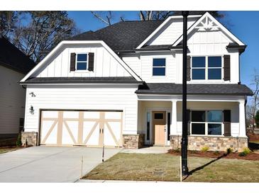 Charming two-story home features a two-car garage, stone accents, and well-maintained landscaping at 505 Brown Dove Ln, Grayson, GA 30017