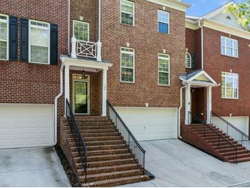 Brick townhomes with inviting entrances and attached garages at 144 Wetherbrooke Ln # 4, Smyrna, GA 30082