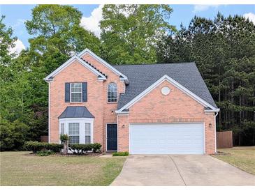 Charming brick home with a well-manicured lawn and two-car garage at 2203 Beacon Crest Dr, Buford, GA 30519
