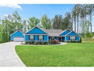 Charming blue home with a well-manicured lawn, complemented by a two-car garage and beautiful landscaping at 505 Alta Ct, Villa Rica, GA 30180