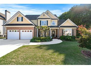 Charming two-story home with a well-manicured lawn, brick accents, and a two-car garage at 2978 Legislative Ln, Buford, GA 30519
