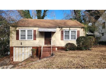 Charming single-Gathering home with a tidy front yard and an unfinished basement garage at 1235 Westboro Sw Dr, Atlanta, GA 30310