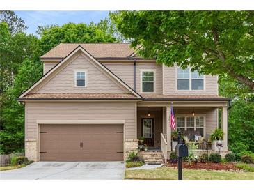 Charming two-story home featuring a covered front porch and well-maintained landscaping at 4876 Briarcliff Dr, Sugar Hill, GA 30518