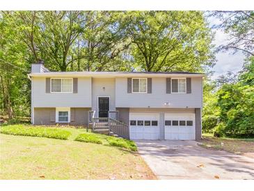 Charming two-story home with attached two-car garage and mature landscaping at 1051 S Millard Way, Stone Mountain, GA 30088