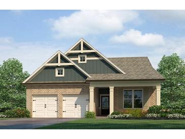 Charming brick home with a two-car garage, decorative gable, and a cozy front porch at 120 Maplewood Ln, Conyers, GA 30094