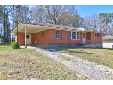 Charming one-story brick home with a covered parking area and a well-maintained front lawn at 118 Ingleside Dr, Jonesboro, GA 30236