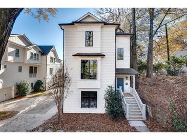 Charming two-story home with white siding, black-trimmed windows, and inviting front steps at 625 Home Se Ave, Atlanta, GA 30312