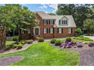 Charming two-story brick home with a well-manicured lawn and colorful landscaping at 1885 Vintage Dr, Snellville, GA 30078