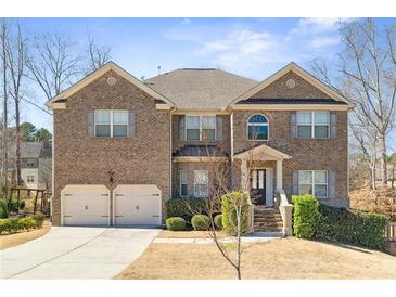Beautiful two-story brick home with a two-car garage, landscaped yard, and inviting front entrance at 4058 Rosebay Way, Conyers, GA 30094