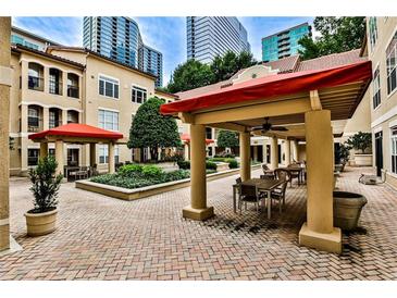 Beautiful courtyard with brick pavers, covered seating, and lush landscaping offers a tranquil retreat at 955 Juniper Ne St # 2322, Atlanta, GA 30309