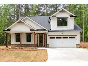 Charming new construction with white siding, stone accents, and a welcoming covered porch at 110 Doris Path, Dallas, GA 30157