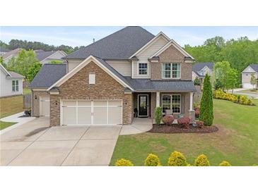 Charming two-story home with a stone and siding exterior, well-manicured lawn, and inviting front porch at 800 Ivy Crest Ln, Canton, GA 30115