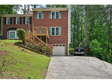 Charming two-story brick home with a front porch, attached garage, and landscaped front yard at 187 Timber Creek Sw Ln, Marietta, GA 30060