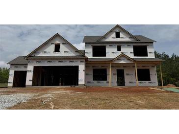 Two-story new construction home featuring a spacious two-car garage and covered front porch awaiting your customization at 1069 Red Oak Blvd, Loganville, GA 30052