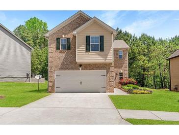 Charming two-story home featuring a brick facade, two-car garage, and beautiful, well-maintained landscaping at 3567 Sycamore Bnd, Decatur, GA 30034