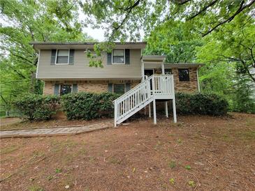 Split level home has a brick and siding facade and a elevated porch and stairs at 4063 Feather Dr, Douglasville, GA 30135