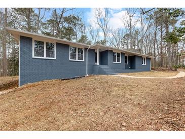 Charming blue brick home with mature trees and manicured landscaping at 4145 White Oak Dr, Winston, GA 30187