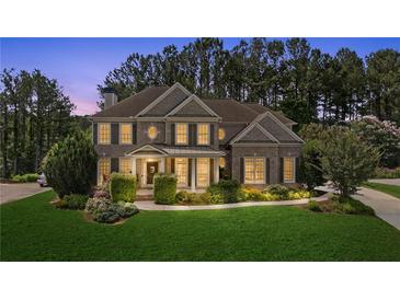 Beautiful brick home featuring manicured landscaping, a covered porch, and a classic architectural design at 249 Thorncliff Lndg, Acworth, GA 30101