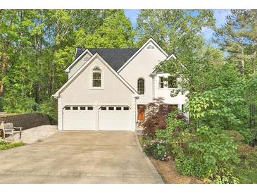 Charming home featuring a two-car garage and beautiful landscaping at 601 Ashley Forest Nw Dr, Acworth, GA 30102