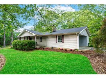 Inviting home exterior featuring a well-manicured lawn and charming curb appeal at 556 Auburn Rd, Auburn, GA 30011