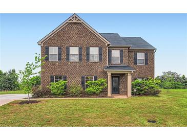 Two-story brick home with black shutters and a well-manicured lawn at 229 Prescott St, Locust Grove, GA 30248